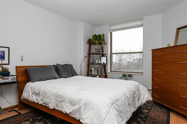 bedroom with wood finished floors