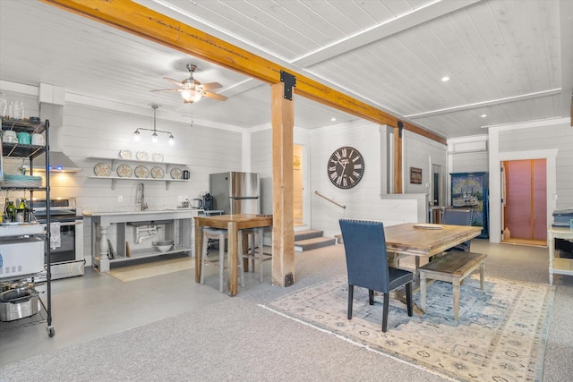 dining area featuring ceiling fan, wood walls, beamed ceiling, and recessed lighting