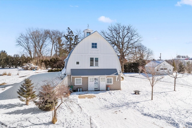 snow covered house with a gambrel roof