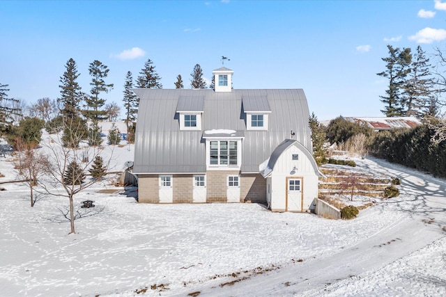 view of snow covered back of property