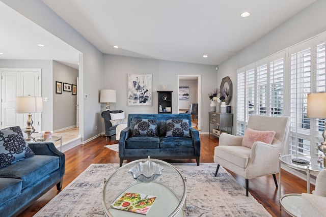 living room featuring baseboards, wood finished floors, and recessed lighting