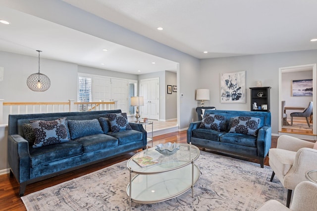 living room with baseboards, wood finished floors, and recessed lighting