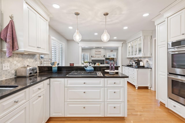 kitchen featuring stainless steel appliances, light wood-type flooring, and white cabinets