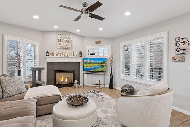 living room featuring recessed lighting, a fireplace, plenty of natural light, and baseboards