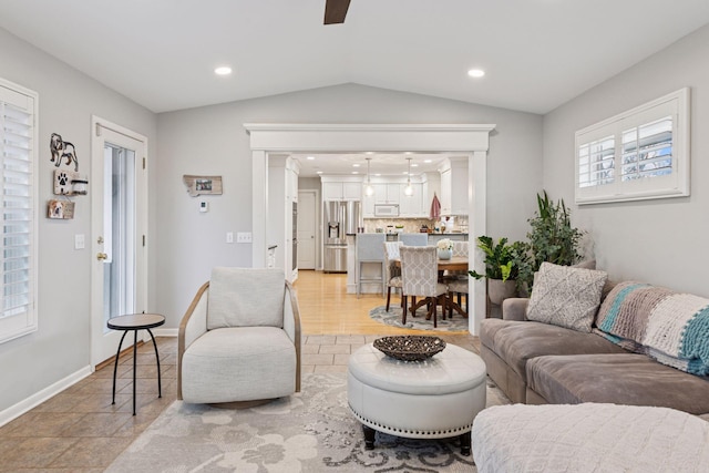 living area with lofted ceiling, baseboards, and recessed lighting