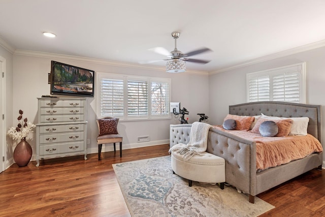 bedroom featuring ceiling fan, ornamental molding, wood finished floors, and baseboards