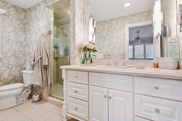 bathroom featuring toilet, wallpapered walls, and a shower stall