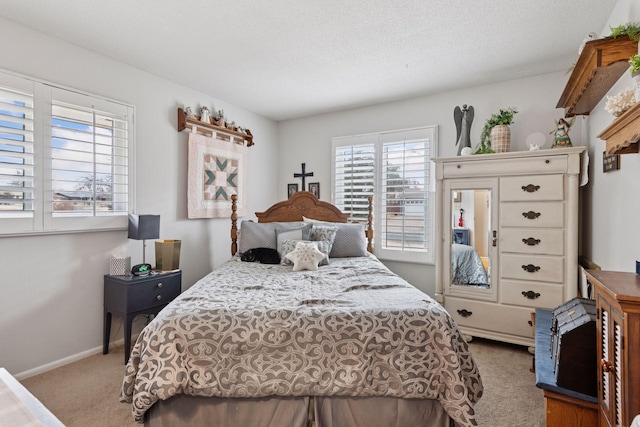 carpeted bedroom with baseboards