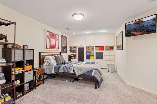 bedroom with carpet floors, visible vents, and baseboards