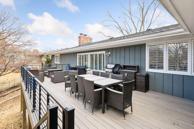 wooden deck with an outdoor hangout area, outdoor dining area, and grilling area