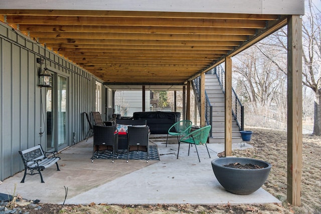 view of patio with outdoor lounge area and stairway