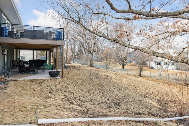 view of yard featuring a patio, fence, a balcony, and stairs