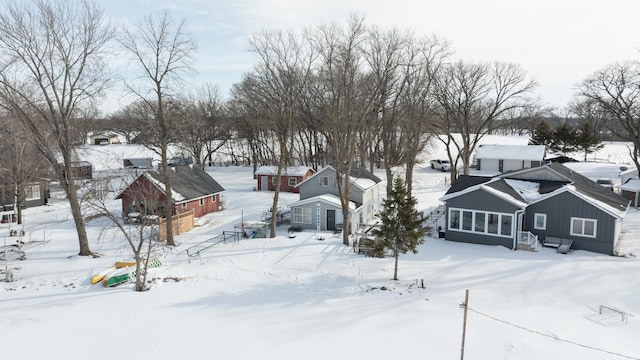 24932 Wall Lake Point Cir, Fergus Falls, MN 56537 - yard covered in snow featuring a garage and a sunroom