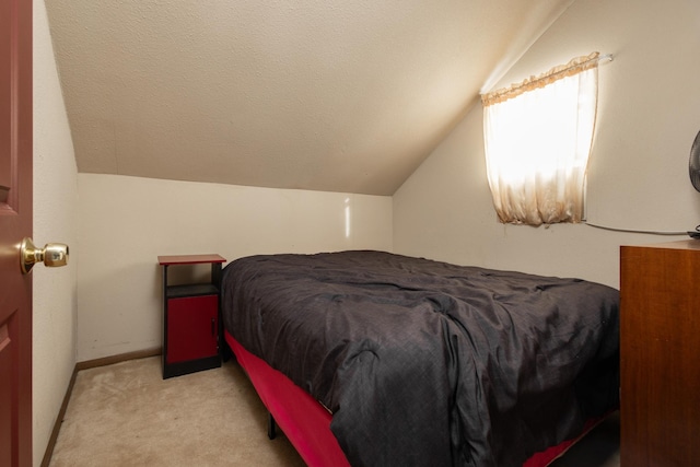 24932 Wall Lake Point Cir, Fergus Falls, MN 56537 - bedroom with baseboards, vaulted ceiling, a textured ceiling, and light colored carpet