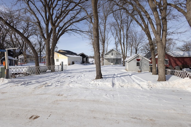 24932 Wall Lake Point Cir, Fergus Falls, MN 56537 - snowy yard featuring an outbuilding, fence, and a residential view