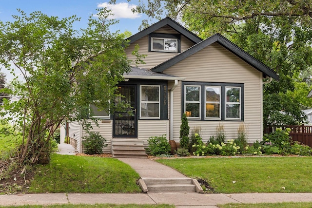 bungalow-style house with entry steps and a front lawn