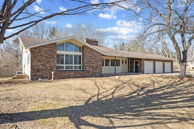 view of front of home featuring brick siding, a chimney, an attached garage, and a shingled roof