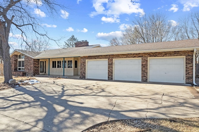 single story home featuring a chimney, an attached garage, concrete driveway, and roof with shingles