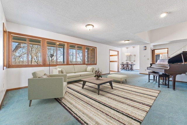 carpeted living area featuring a wealth of natural light, baseboards, a textured ceiling, and an inviting chandelier