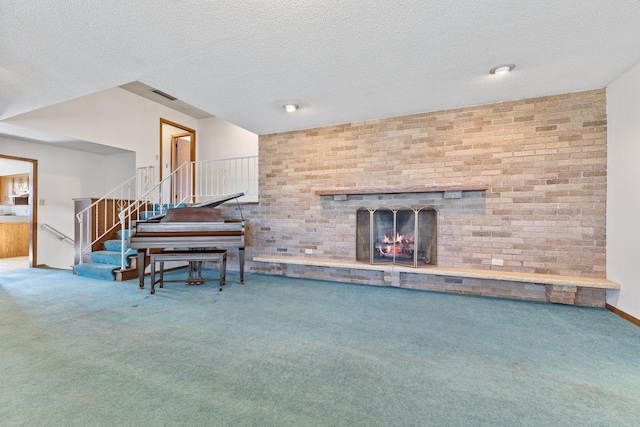 living area with stairs, carpet, visible vents, and a fireplace