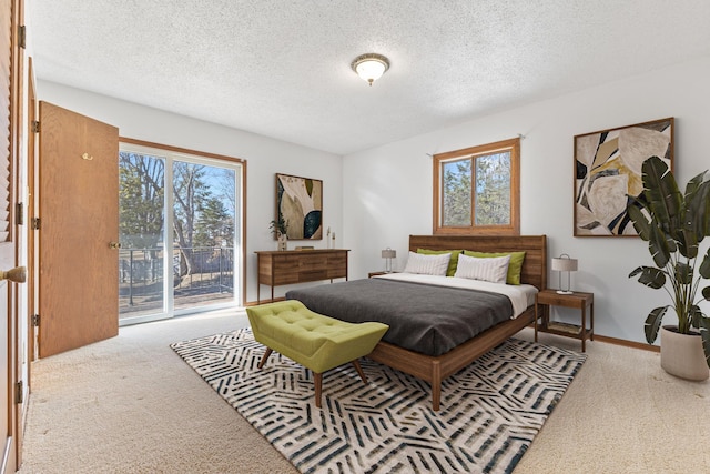 carpeted bedroom featuring baseboards, a textured ceiling, and access to outside