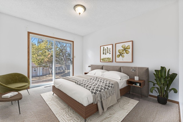 carpeted bedroom with baseboards, a textured ceiling, and access to outside