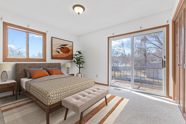 bedroom with light carpet, multiple windows, baseboards, and access to outside