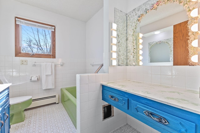 bathroom featuring a baseboard heating unit, tile walls, plenty of natural light, and vanity