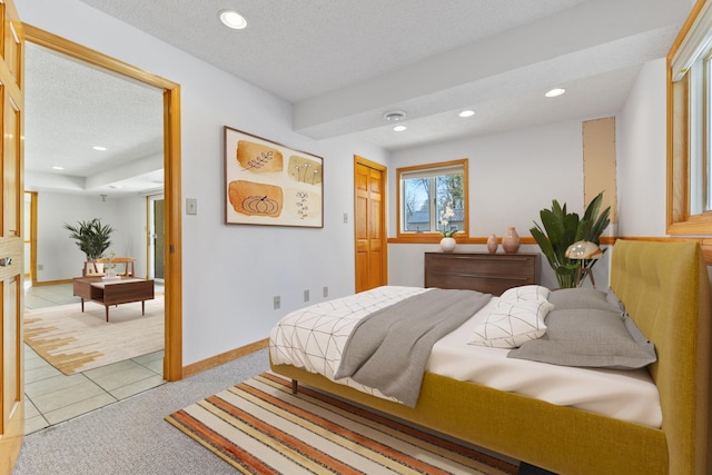 bedroom featuring light colored carpet, recessed lighting, baseboards, and a textured ceiling