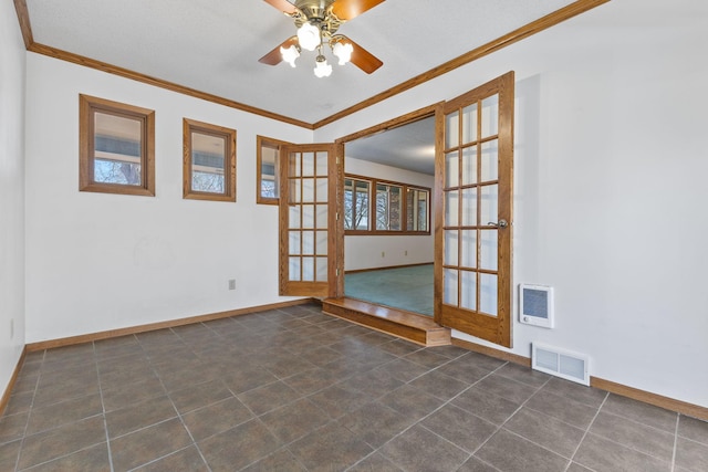 spare room with visible vents, ceiling fan, crown molding, and baseboards