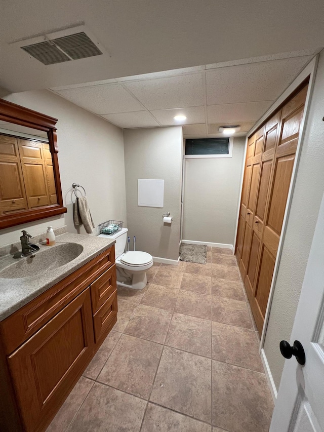 502 19th St N, Benson, MN 56215 - bathroom featuring toilet, vanity, and a drop ceiling