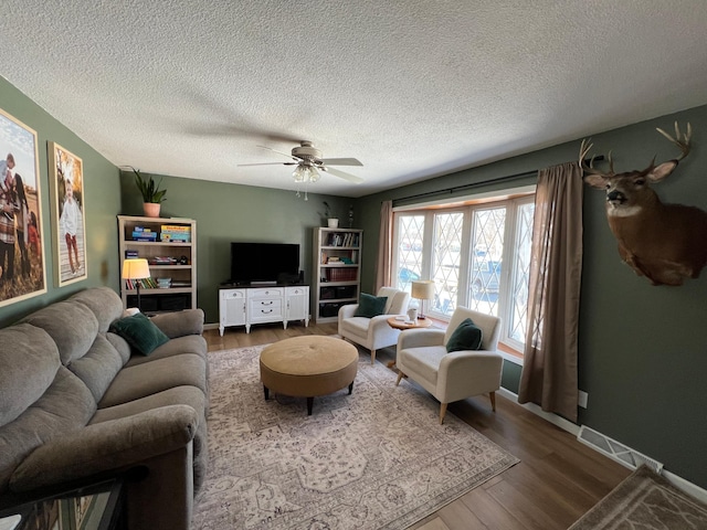 502 19th St N, Benson, MN 56215 - living area with wood finished floors, a textured ceiling, and a ceiling fan