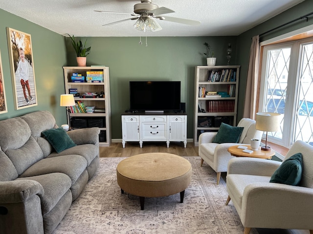 502 19th St N, Benson, MN 56215 - living room with wood finished floors, a textured ceiling, a ceiling fan, and baseboards