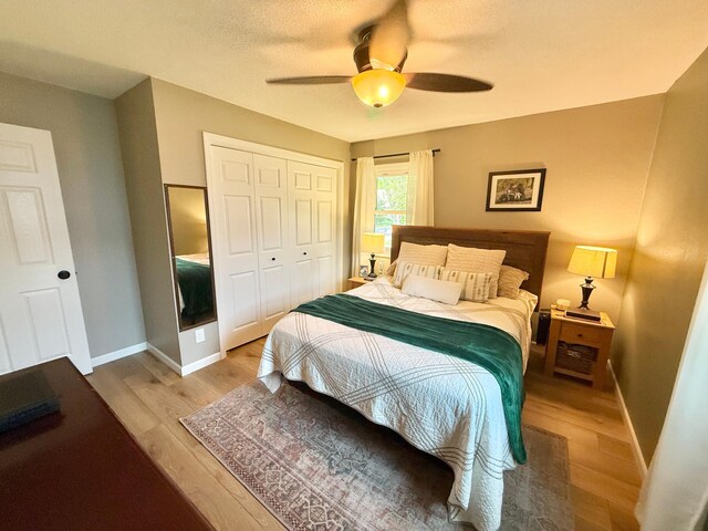 502 19th St N, Benson, MN 56215 - bedroom featuring light wood-style floors, a closet, baseboards, and a ceiling fan