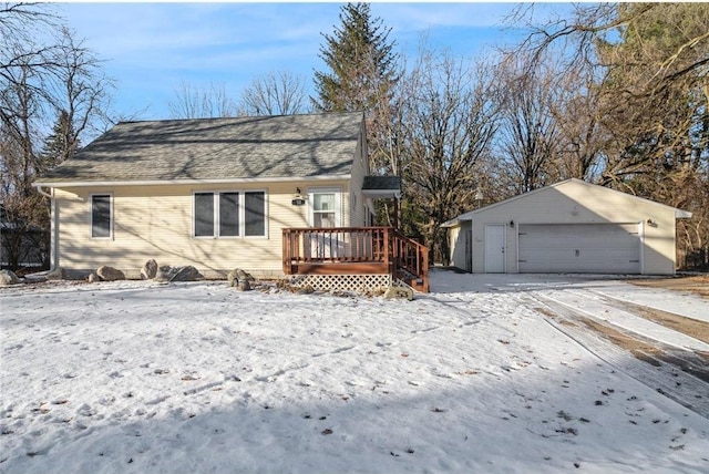 view of front of property with a wooden deck, a detached garage, roof with shingles, and an outdoor structure