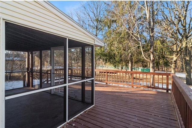 wooden deck with a sunroom