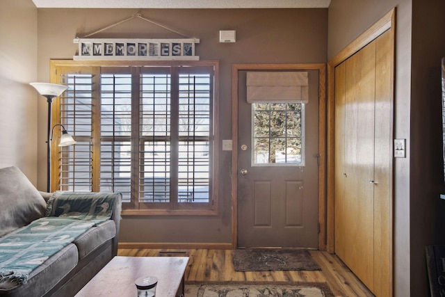 foyer entrance with wood finished floors and visible vents