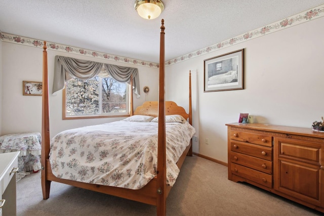 bedroom with light carpet, baseboards, and a textured ceiling