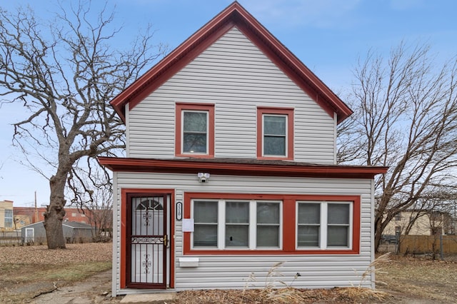 view of front of home featuring fence