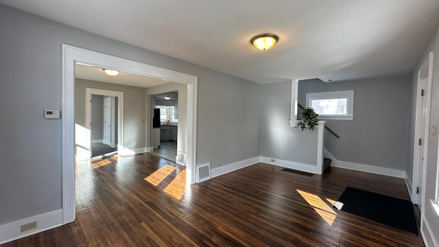 interior space with visible vents, dark wood finished floors, and baseboards