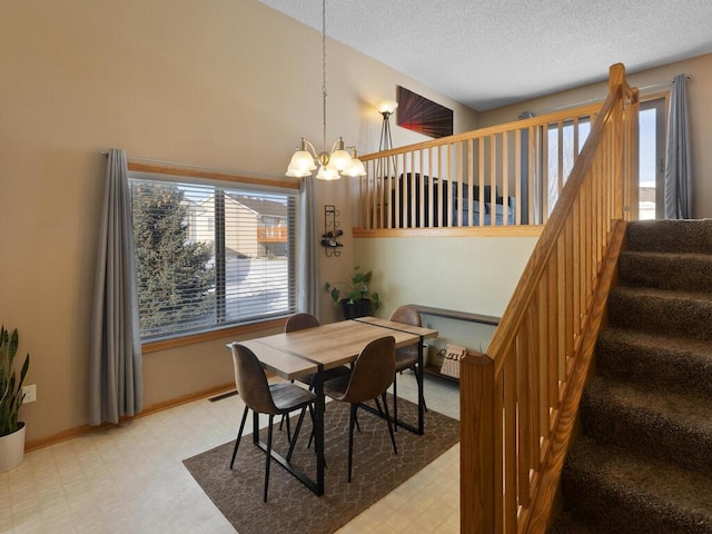 dining area featuring light floors, stairway, a textured ceiling, a chandelier, and baseboards