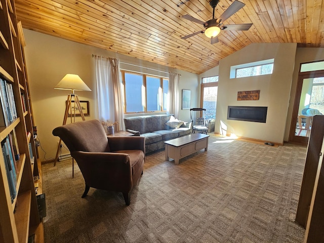 living room with a ceiling fan, a glass covered fireplace, dark colored carpet, baseboards, and wood ceiling