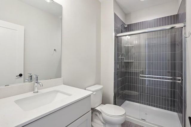 full bathroom with a stall shower, vanity, and toilet