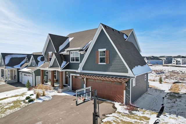 view of front of house featuring driveway, a garage, and a residential view