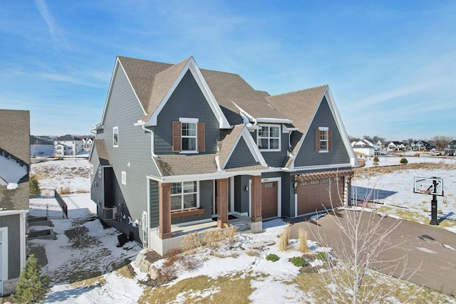 view of front of home with a shingled roof and driveway