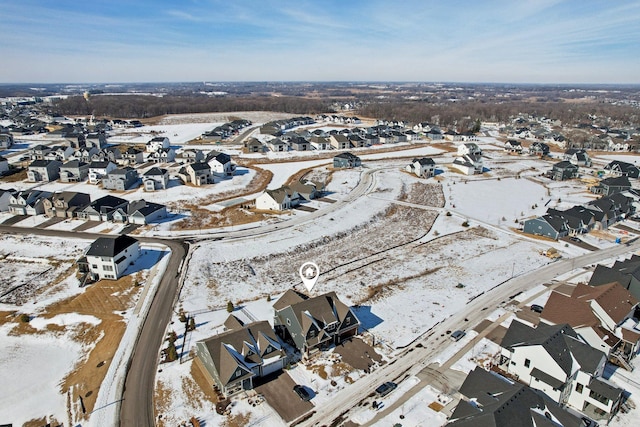 snowy aerial view with a residential view