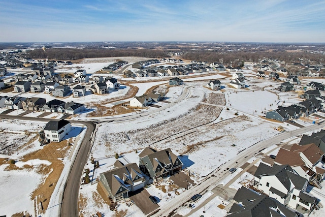 snowy aerial view featuring a residential view