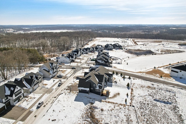 snowy aerial view featuring a residential view