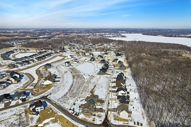 snowy aerial view with a residential view