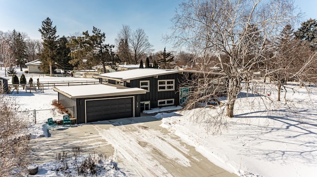 view of front facade featuring board and batten siding and fence